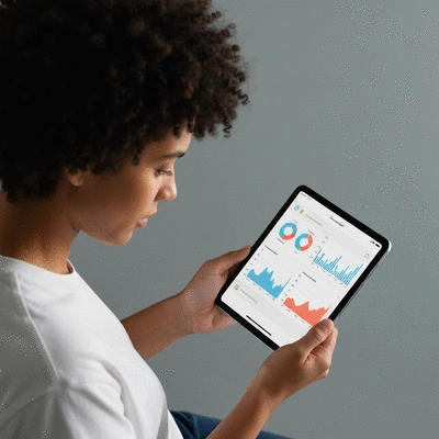 Person reviewing personalized health data on a tablet, showing graphs and charts related to blood sugar levels